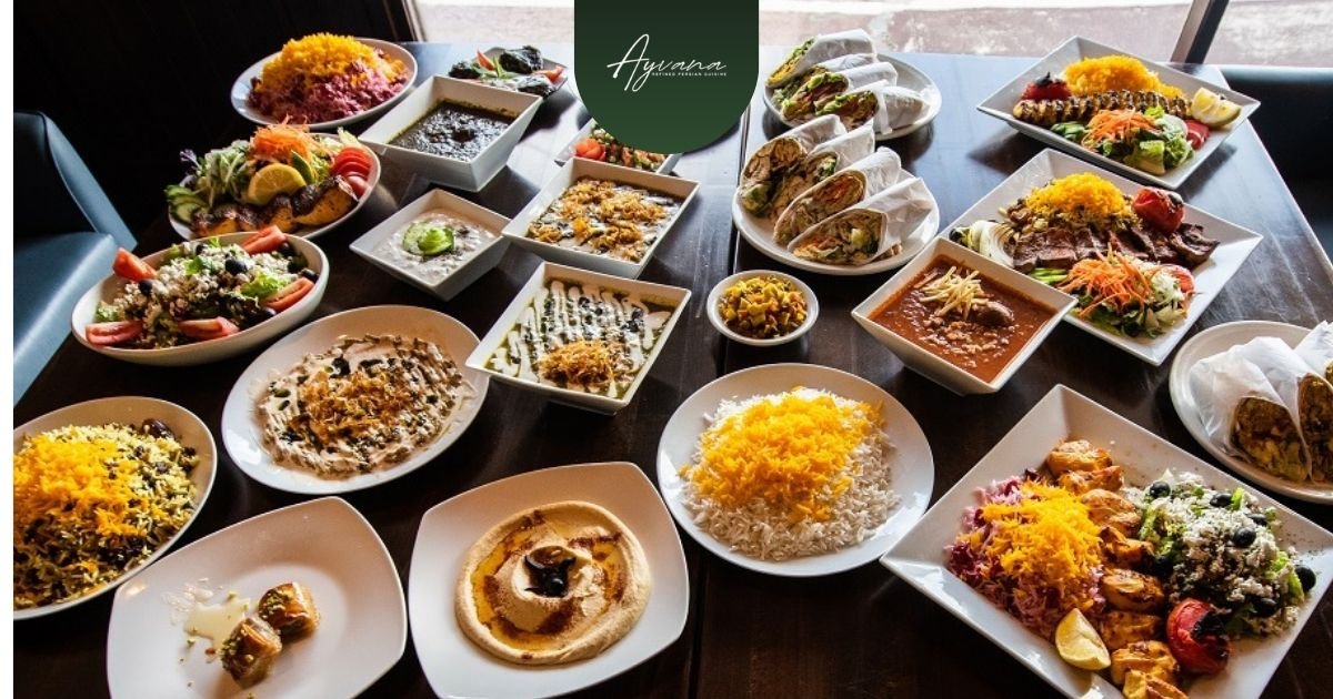 Abundant spread of colorful Persian dishes featuring saffron rice, kebabs, wraps, salads, stews, and appetizers on a restaurant table.