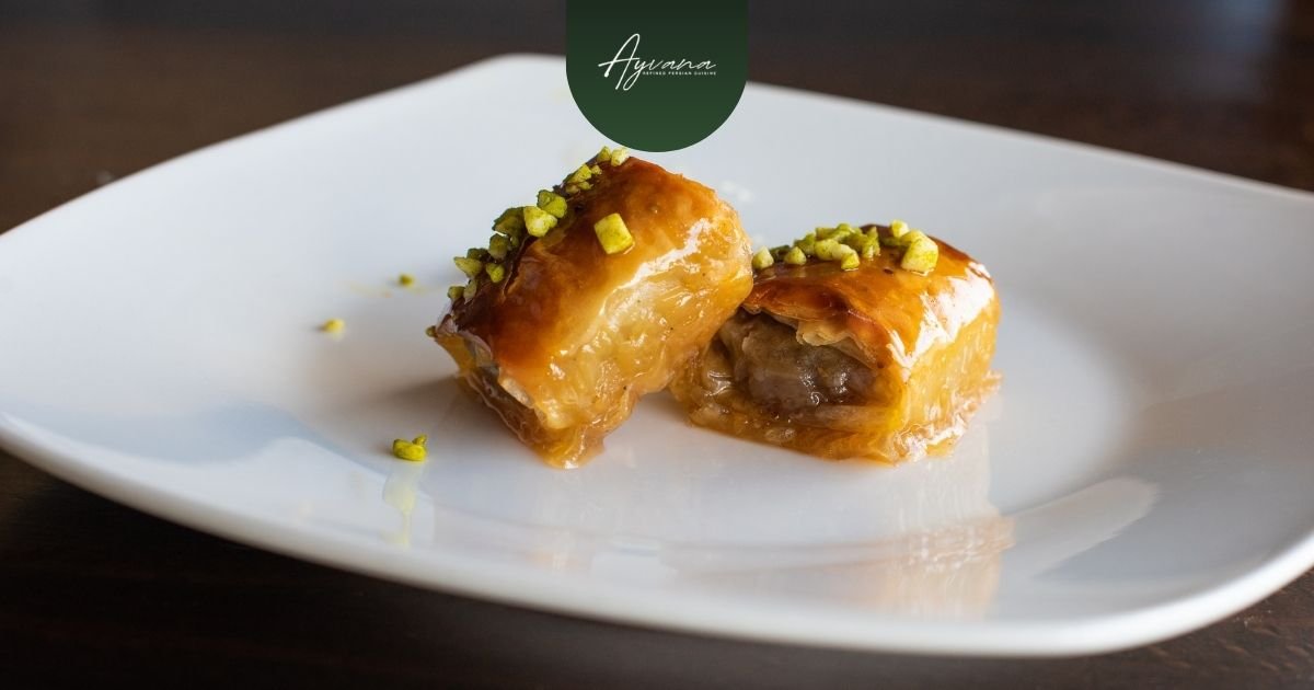 Persian baklava made with layers of pastry, nuts, and sweet syrup arranged on a dessert platter