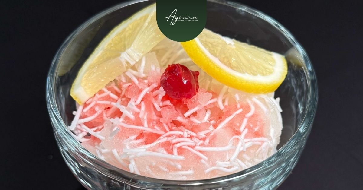 Traditional Persian Faloodeh dessert made with rosewater syrup, thin rice noodles, crushed ice, lemon, and cherry