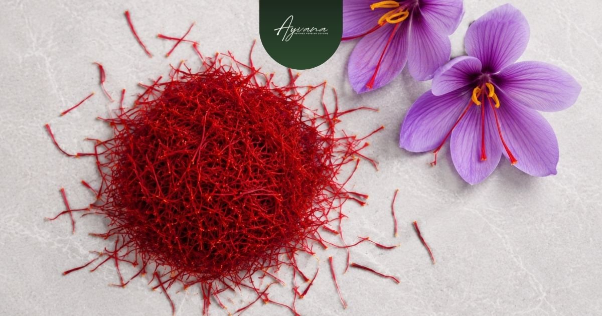 Premium saffron threads with blooming purple crocus flowers displayed on elegant marble surface beside Ayvana restaurant branding.