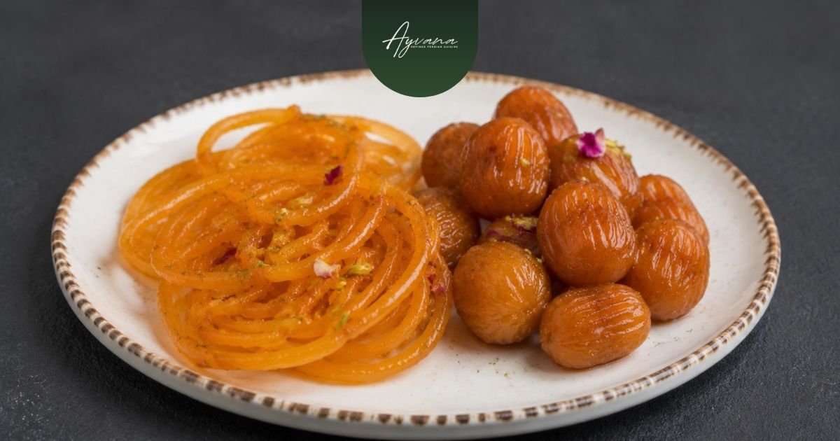 Traditional Persian zoolbia and bamieh served on a dessert platter with sweet syrup glaze